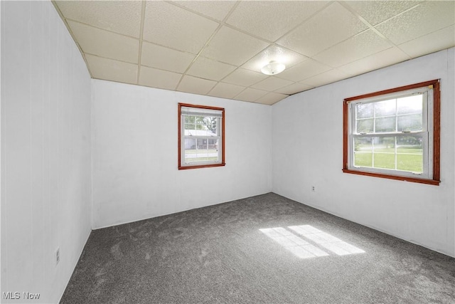 empty room with a paneled ceiling and carpet