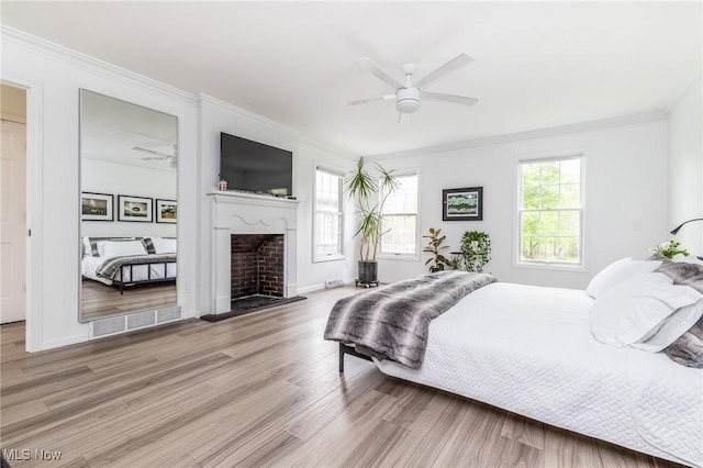 675 Wheatfield Dr, Aurora, OH 44202 - bedroom with ornamental molding, wood finished floors, a fireplace, a ceiling fan, and baseboards