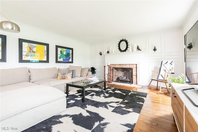 675 Wheatfield Dr, Aurora, OH 44202 - living area with wood finished floors, ornamental molding, a fireplace, and a decorative wall