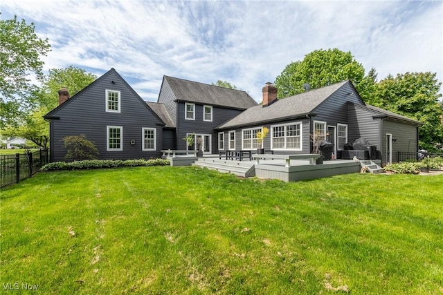 675 Wheatfield Dr, Aurora, OH 44202 - rear view of property featuring a chimney, a wooden deck, and roof with shingles