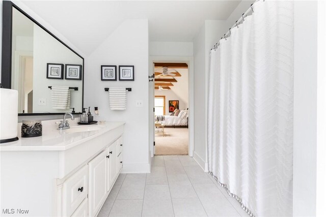 675 Wheatfield Dr, Aurora, OH 44202 - ensuite bathroom with lofted ceiling, tile patterned floors, vanity, and baseboards