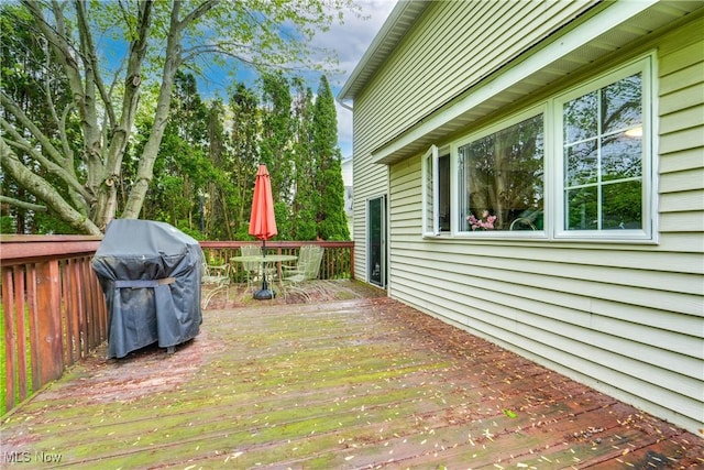 wooden deck featuring outdoor dining area and area for grilling
