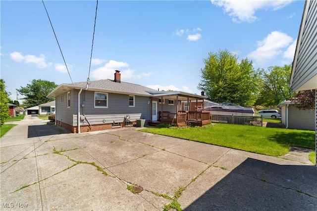 4760 Autumn Ln, Brooklyn, OH 44144 - back of house featuring a chimney, a wooden deck, and driveway