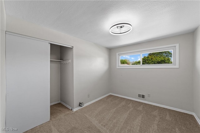 4760 Autumn Ln, Brooklyn, OH 44144 - unfurnished bedroom featuring carpet, a textured ceiling, baseboards, and a closet