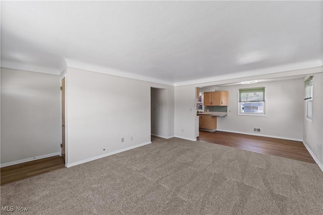 4760 Autumn Ln, Brooklyn, OH 44144 - unfurnished living room with dark colored carpet and baseboards