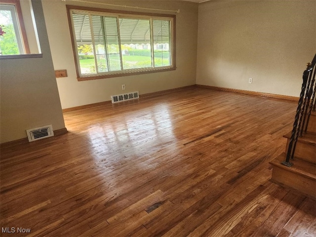 empty room featuring wood finished floors and baseboards