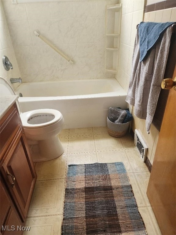 bathroom featuring toilet, vanity, tile patterned floors, and shower / bath combination