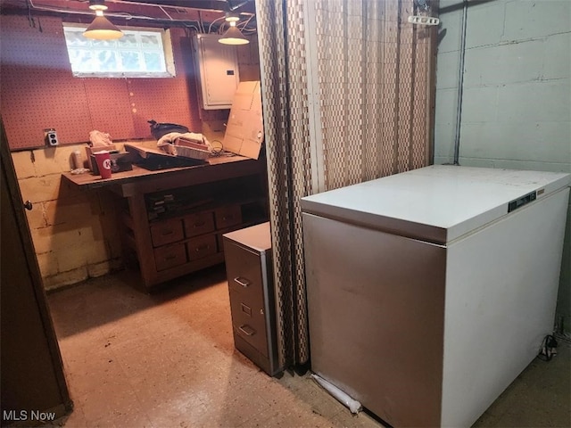 laundry room with light floors and electric panel
