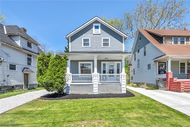 traditional style home featuring covered porch and a front lawn