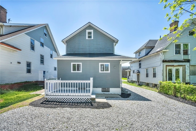 rear view of property with a wooden deck