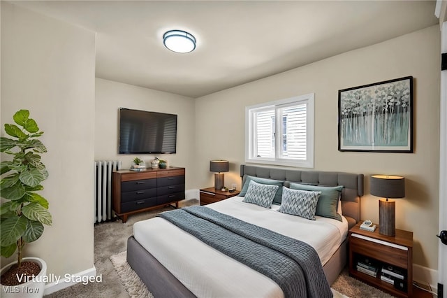 bedroom with radiator, baseboards, and carpet floors