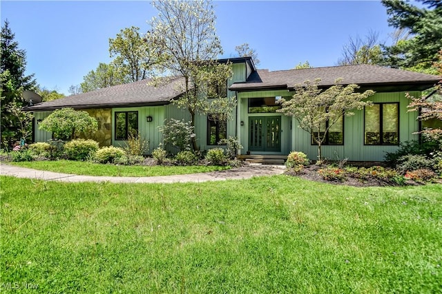 8220 Hermitage Rd, Concord, OH 44077 - view of front of property with french doors, a front yard, and a shingled roof