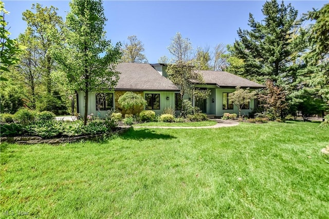 8220 Hermitage Rd, Concord, OH 44077 - view of front of home with a front lawn and roof with shingles
