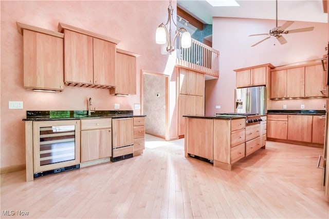 8220 Hermitage Rd, Concord, OH 44077 - kitchen featuring light brown cabinets, wine cooler, stainless steel appliances, high vaulted ceiling, and dark countertops