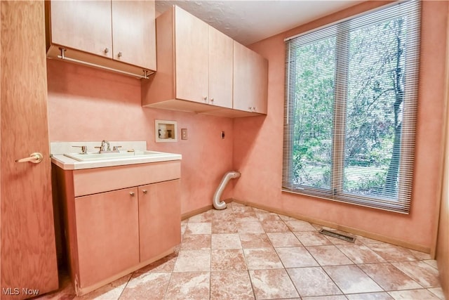 8220 Hermitage Rd, Concord, OH 44077 - washroom with cabinet space, washer hookup, plenty of natural light, and electric dryer hookup
