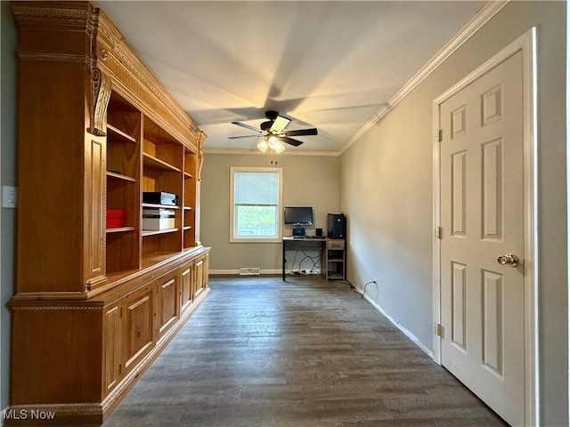 office area featuring a ceiling fan, crown molding, dark wood finished floors, and baseboards