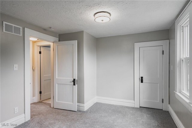 406 39th St, Vienna, WV 26105 - unfurnished bedroom featuring carpet flooring, baseboards, and a textured ceiling