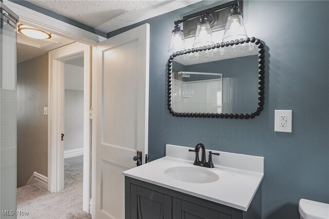 406 39th St, Vienna, WV 26105 - bathroom featuring vanity, toilet, a textured ceiling, and baseboards