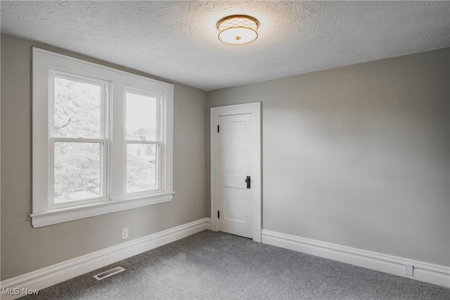 406 39th St, Vienna, WV 26105 - carpeted empty room featuring a textured ceiling and baseboards