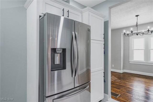 406 39th St, Vienna, WV 26105 - kitchen with stainless steel refrigerator with ice dispenser, white cabinets, a chandelier, baseboards, and wood finished floors