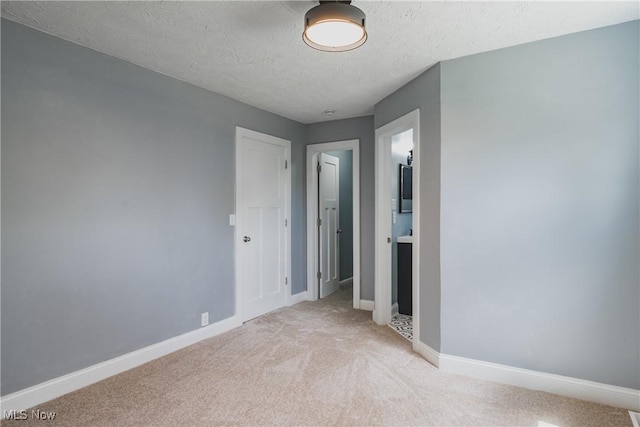 406 39th St, Vienna, WV 26105 - unfurnished bedroom featuring light colored carpet, a textured ceiling, and baseboards