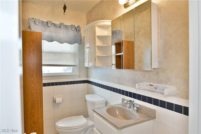 9960 Ridge Rdg, Farmdale, OH 44417 - half bathroom with toilet, vanity, tile walls, and wainscoting