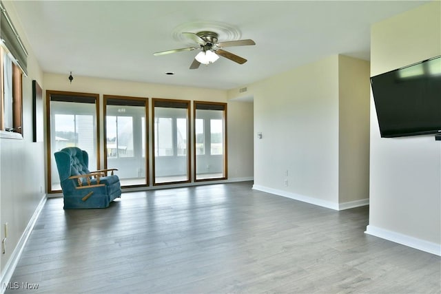 9960 Ridge Rdg, Farmdale, OH 44417 - unfurnished living room featuring healthy amount of natural light, ceiling fan, and wood finished floors
