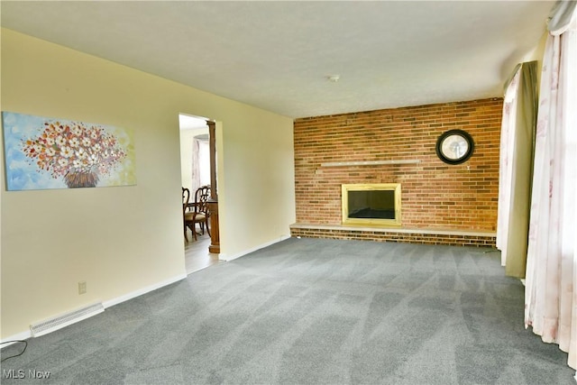 9960 Ridge Rdg, Farmdale, OH 44417 - unfurnished living room featuring carpet, a fireplace, baseboards, and brick wall