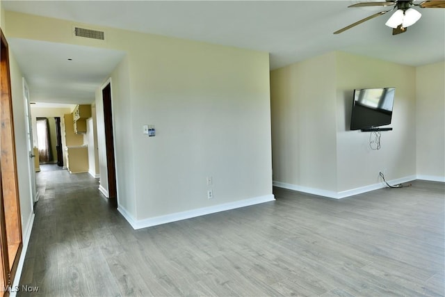 9960 Ridge Rdg, Farmdale, OH 44417 - unfurnished living room with wood finished floors, a ceiling fan, and baseboards
