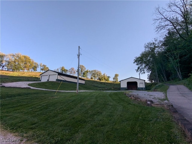 5216 Arrow Rd NW, Minerva, OH 44657 - view of green lawn featuring a garage and an outdoor structure