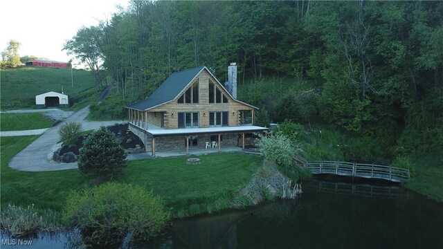 5216 Arrow Rd NW, Minerva, OH 44657 - back of house with a chimney, a yard, and an outbuilding