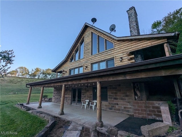 5216 Arrow Rd NW, Minerva, OH 44657 - rear view of house featuring a patio and a chimney