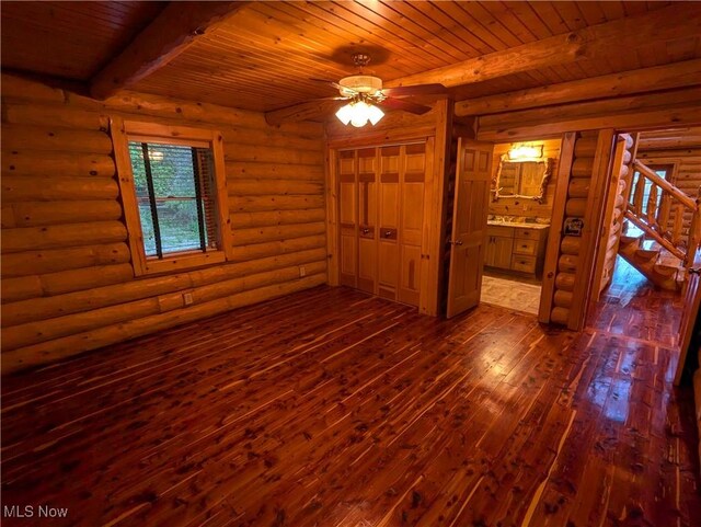 5216 Arrow Rd NW, Minerva, OH 44657 - spare room with wood ceiling, beamed ceiling, dark wood finished floors, stairs, and a ceiling fan