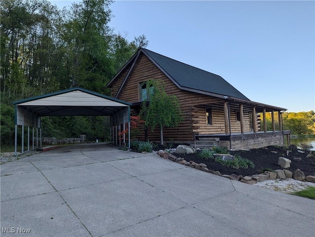 5216 Arrow Rd NW, Minerva, OH 44657 - view of property exterior featuring driveway, log exterior, a carport, and a porch