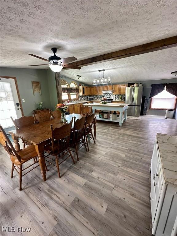 1367 Arner Rd, Chester, WV 26034 - dining area featuring a textured ceiling, healthy amount of natural light, light wood-type flooring, ceiling fan, and beamed ceiling