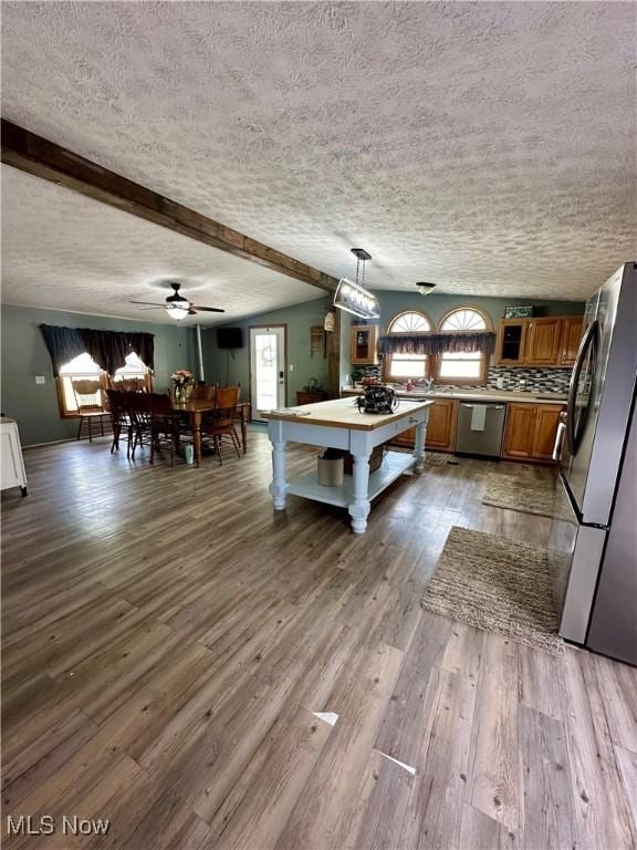 1367 Arner Rd, Chester, WV 26034 - kitchen with appliances with stainless steel finishes, brown cabinets, a textured ceiling, dark wood finished floors, and light countertops