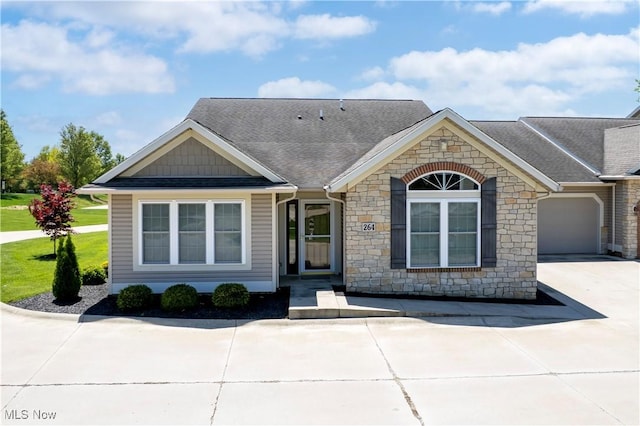 2618 Weatherington Ln Unit 264, Wooster, OH 44691 - view of front of home featuring stone siding, a shingled roof, and driveway