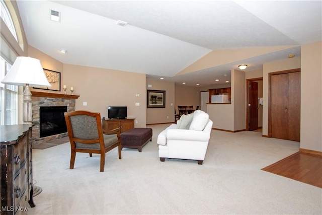 2618 Weatherington Ln Unit 264, Wooster, OH 44691 - living room featuring lofted ceiling, a stone fireplace, light colored carpet, and baseboards