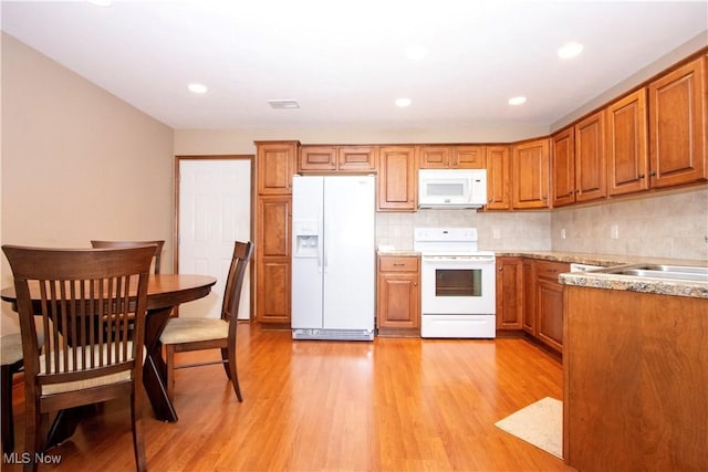2618 Weatherington Ln Unit 264, Wooster, OH 44691 - kitchen with white appliances, brown cabinetry, light wood-type flooring, and recessed lighting