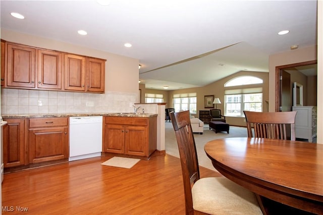 2618 Weatherington Ln Unit 264, Wooster, OH 44691 - kitchen with white dishwasher, brown cabinets, light wood-type flooring, a peninsula, and lofted ceiling