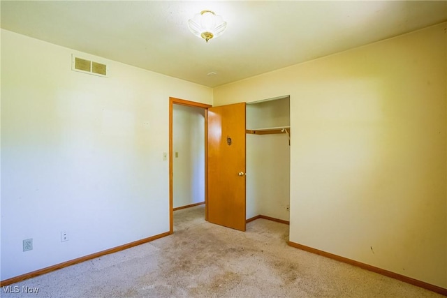 265 Franklin Dr, Doylestown, OH 44230 - unfurnished bedroom with a closet, baseboards, and light colored carpet