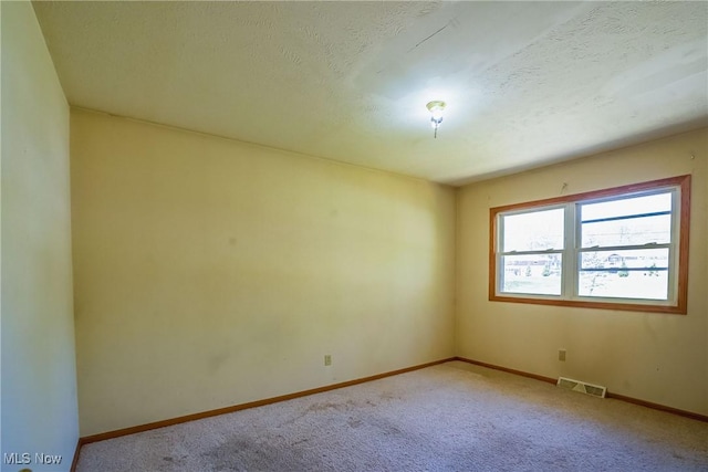 265 Franklin Dr, Doylestown, OH 44230 - empty room featuring carpet flooring, baseboards, and a textured ceiling