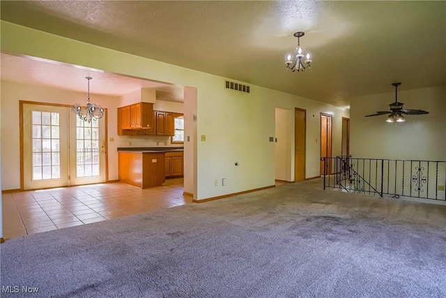 265 Franklin Dr, Doylestown, OH 44230 - unfurnished living room with a chandelier, light carpet, baseboards, and light tile patterned flooring