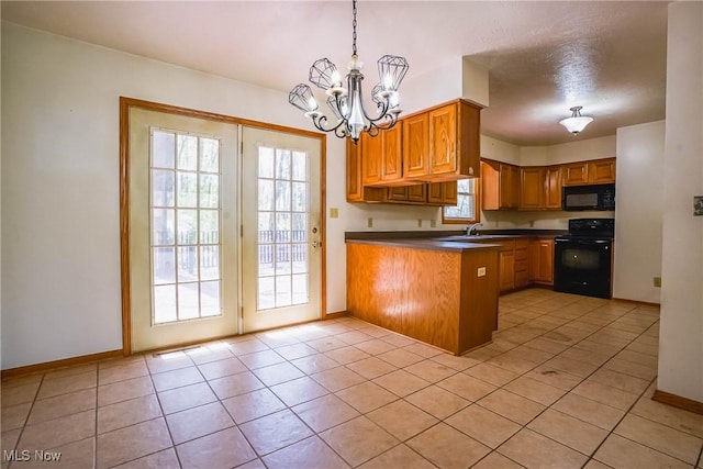 265 Franklin Dr, Doylestown, OH 44230 - kitchen featuring range, black microwave, a peninsula, dark countertops, and a sink