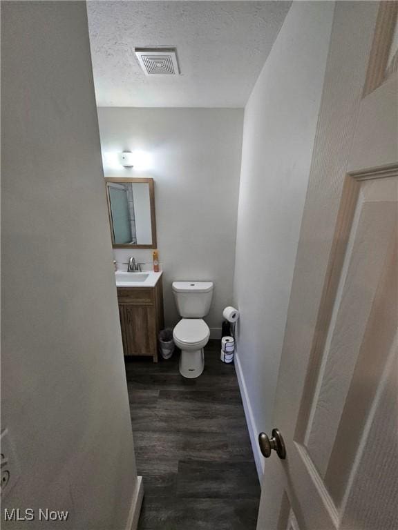5897 Kimberly Dr, Bedford Heights, OH 44146 - half bath with wood finished floors, vanity, and a textured ceiling
