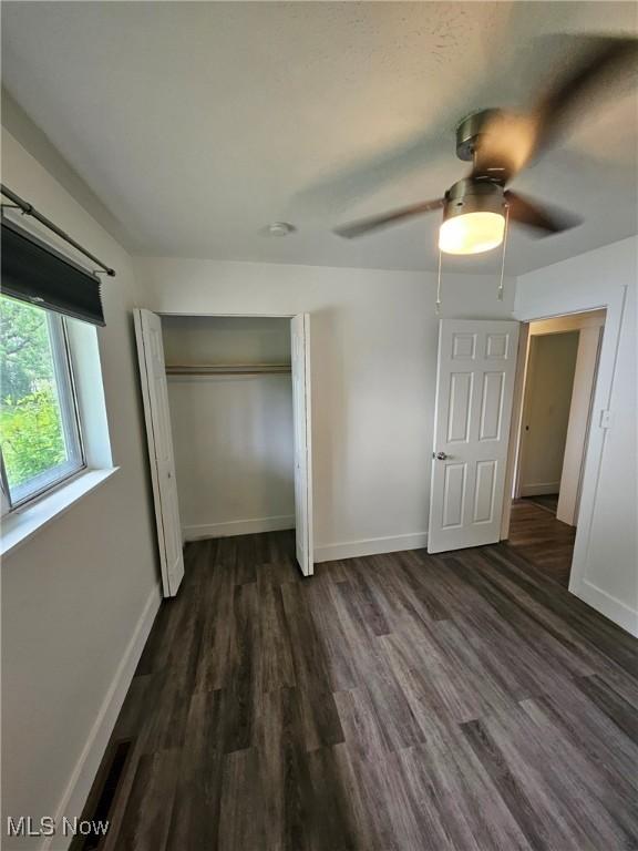 5897 Kimberly Dr, Bedford Heights, OH 44146 - unfurnished bedroom with wood finished floors, a closet, and ceiling fan