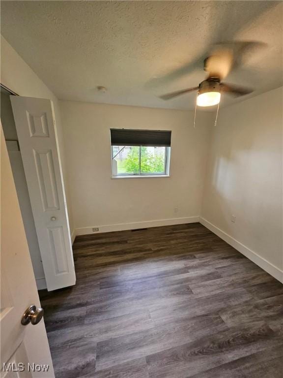 5897 Kimberly Dr, Bedford Heights, OH 44146 - unfurnished bedroom featuring a textured ceiling, dark wood finished floors, and ceiling fan