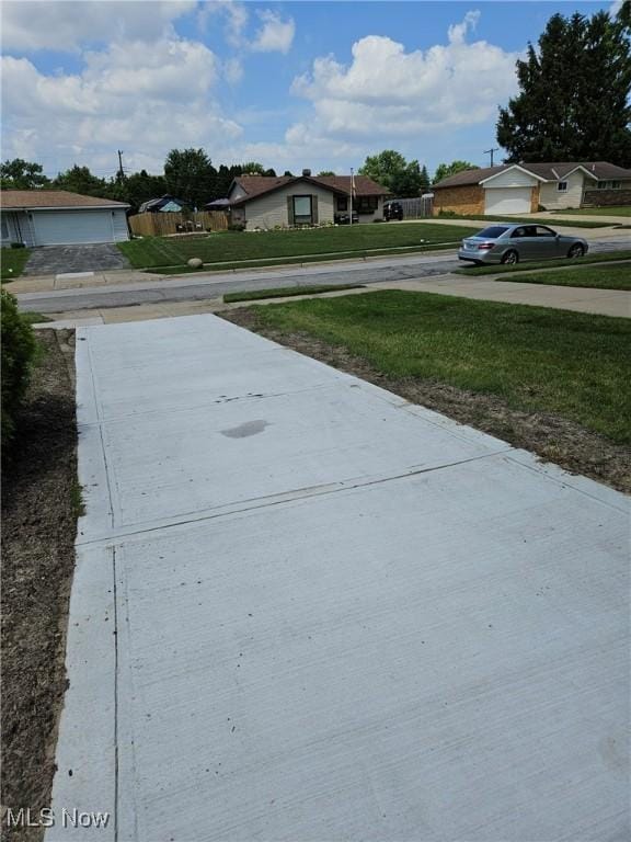 5897 Kimberly Dr, Bedford Heights, OH 44146 - view of green lawn with a residential view and concrete driveway
