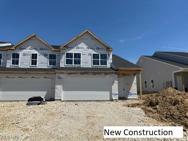 420 Honeycrisp Dr NE, Louisville, OH 44641 - property under construction featuring a garage and gravel driveway