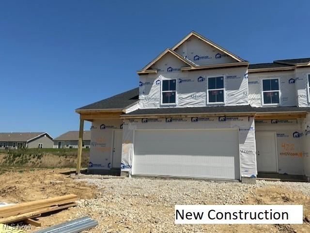 424 Honeycrisp Dr NE, Louisville, OH 44641 - property in mid-construction featuring an attached garage